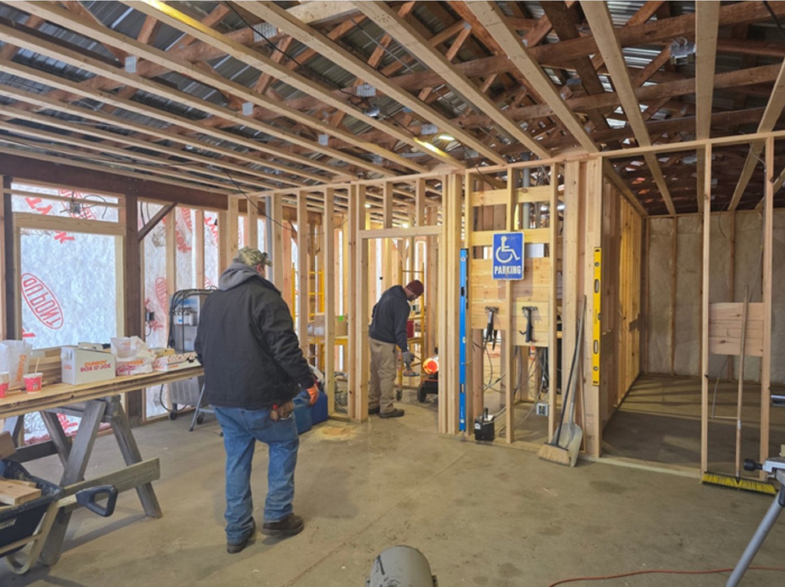 Crew inside the wood-framed welcome center building